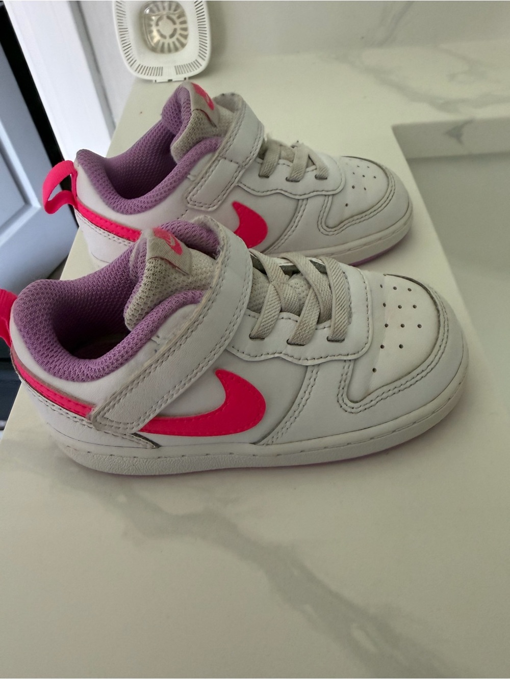 Nike Kids White Sneakers with Pink Swoosh and Lavender Lining